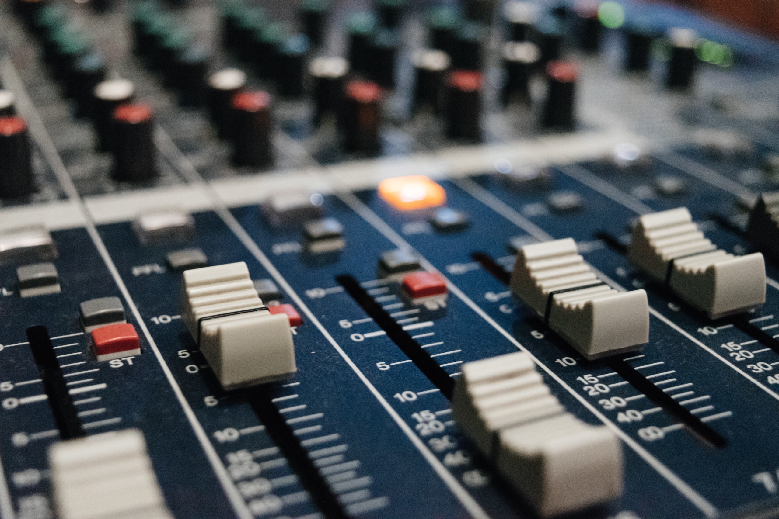 This is a photo of a sound board with various buttons used to equalize. Photo by Alexey Ruban.